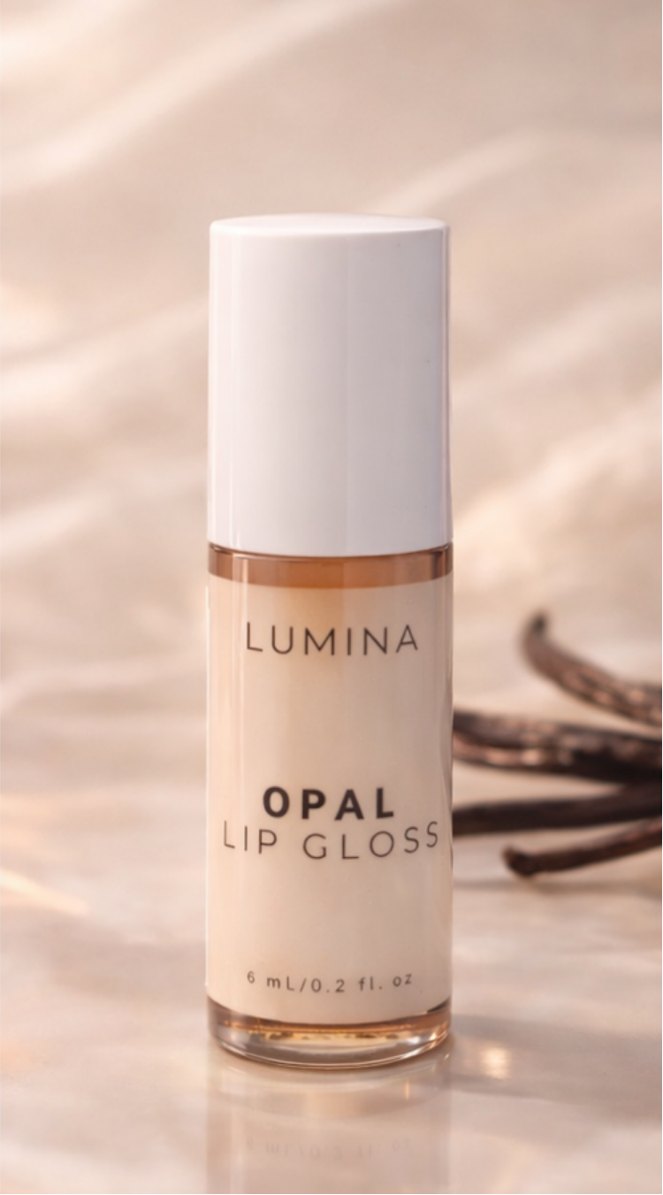Lumina Opal lip gloss bottle on a reflective surface with a blurred background